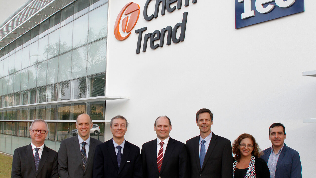 Group picture of the management in front of the new site